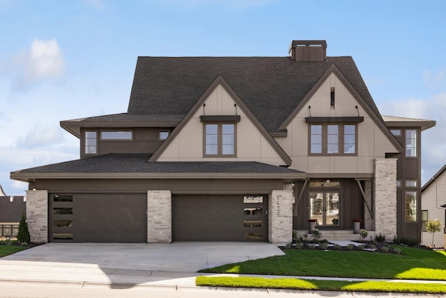 view of front of property featuring a garage and a front lawn