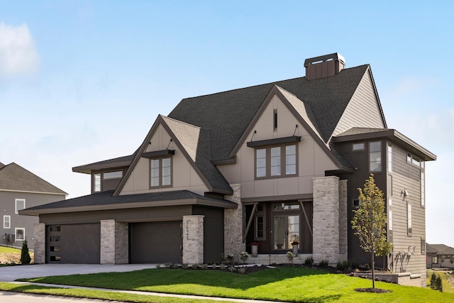 view of front of home with a front yard and a garage