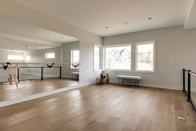 workout room featuring light wood-type flooring