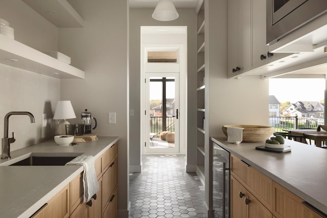 kitchen with wine cooler and sink