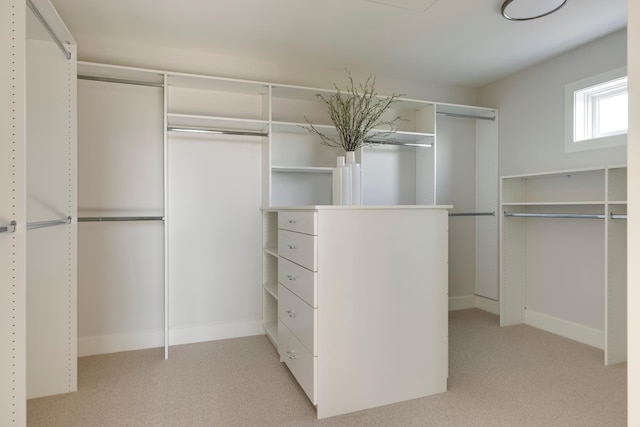 walk in closet featuring light colored carpet