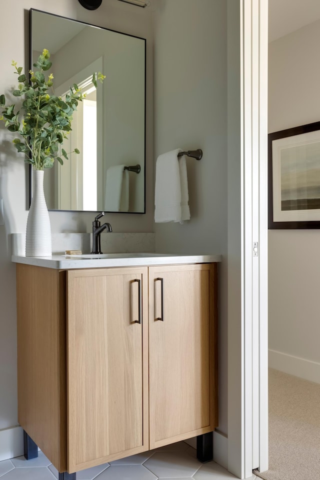 bathroom with tile patterned flooring and vanity