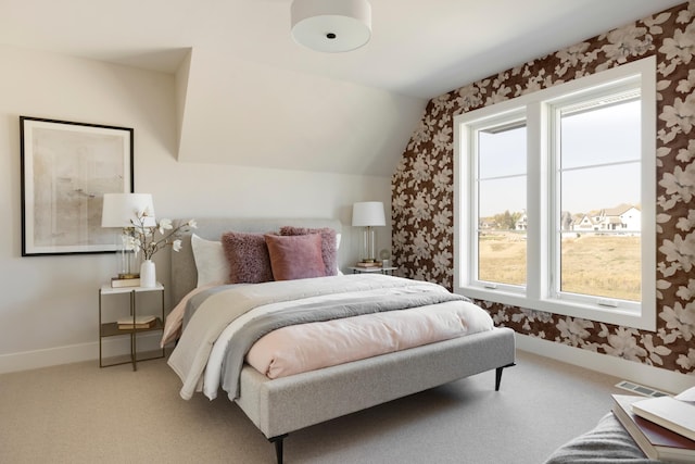 carpeted bedroom with lofted ceiling