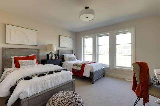 bedroom featuring light carpet