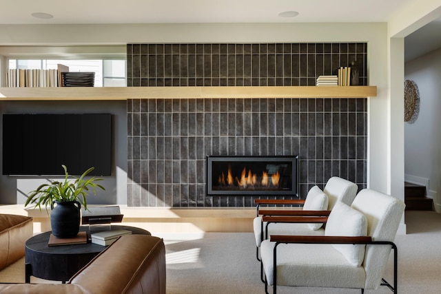 living room featuring a fireplace and carpet flooring