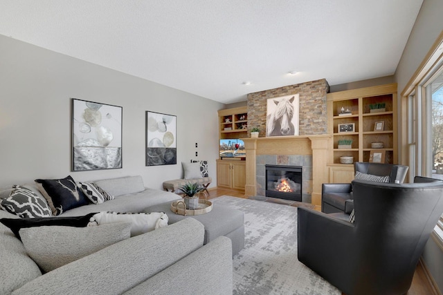 living area with a tile fireplace