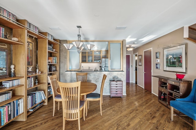 dining area with dark hardwood / wood-style flooring