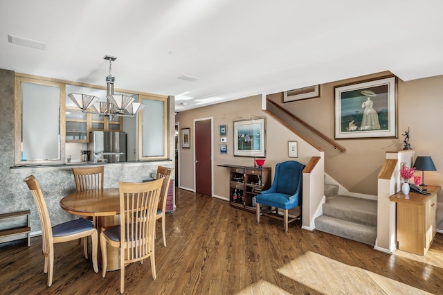 dining room with an inviting chandelier and hardwood / wood-style flooring