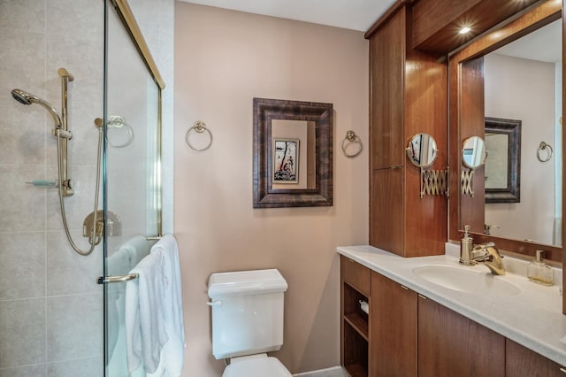 bathroom featuring toilet, vanity, and walk in shower