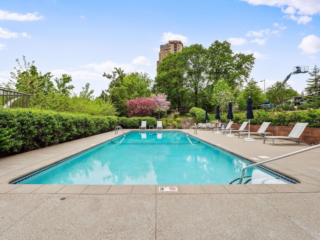 view of swimming pool with a patio area