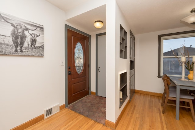 entryway with light hardwood / wood-style flooring