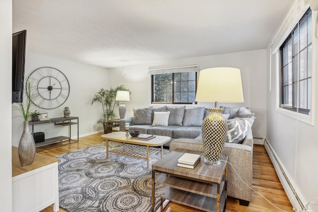 living room featuring hardwood / wood-style flooring and a baseboard heating unit