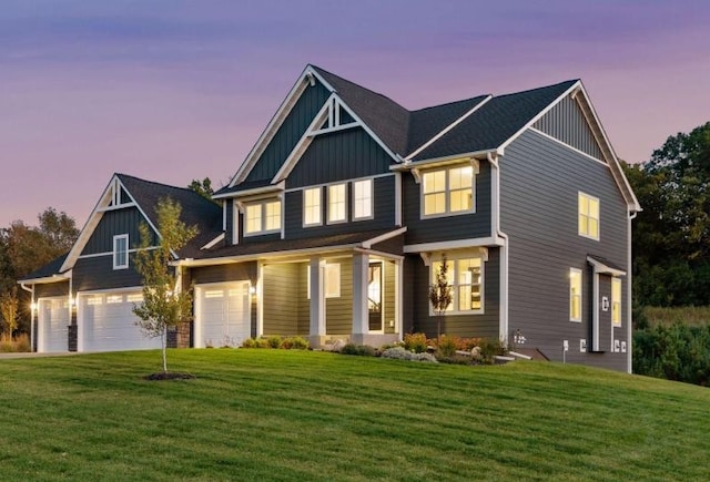 craftsman house with a yard and a garage