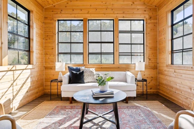 sunroom featuring vaulted ceiling and a healthy amount of sunlight