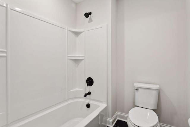 bathroom with tub / shower combination and toilet