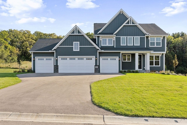 craftsman-style home featuring a garage and a front yard