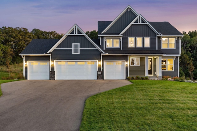 craftsman inspired home with a garage and a yard