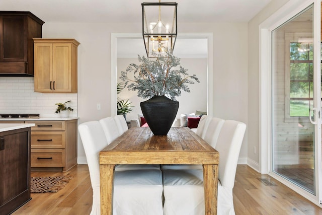 dining space featuring a chandelier and light hardwood / wood-style floors