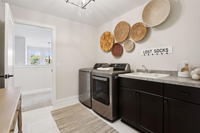 laundry room with cabinets, sink, and washer and dryer