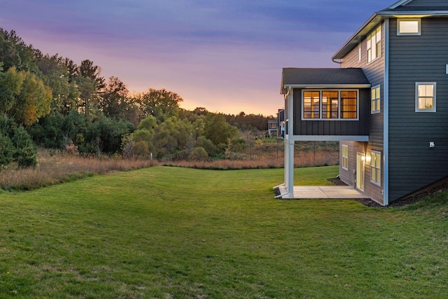 yard at dusk with a patio area