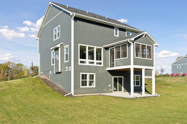 back of property with a patio and a yard