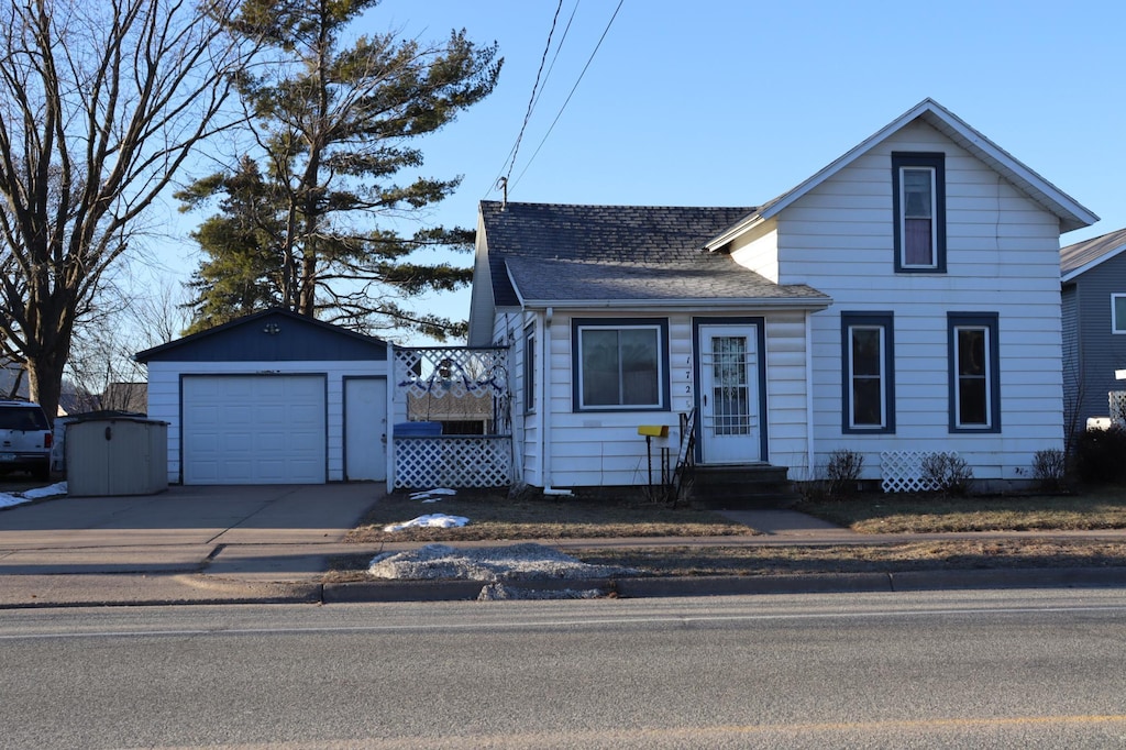 view of front of home featuring a garage and an outdoor structure