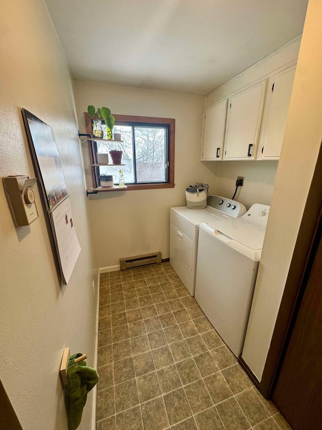 laundry area with washer and dryer, baseboard heating, and cabinets