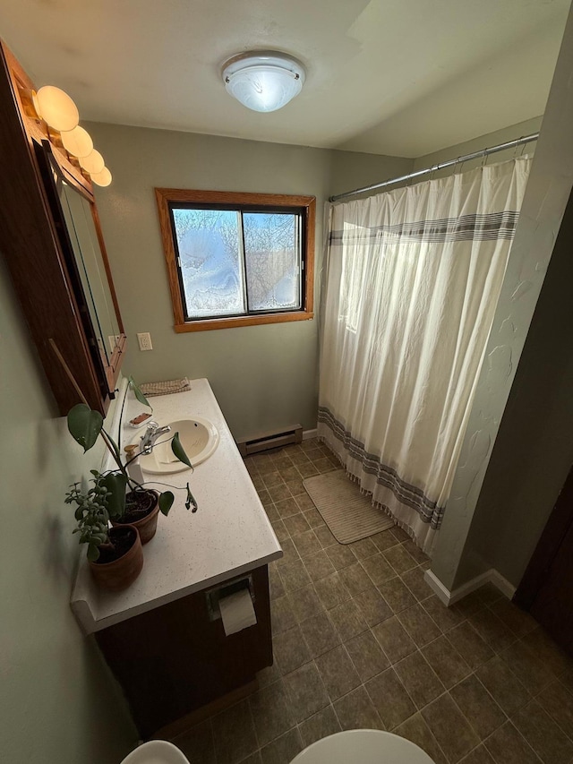 bathroom featuring a shower with curtain, vanity, and a baseboard heating unit