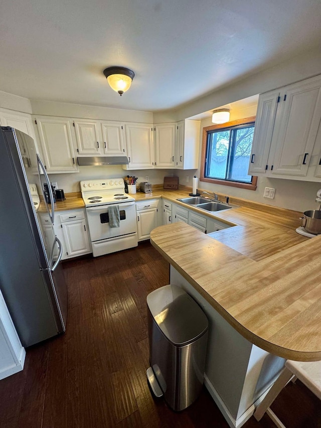 kitchen featuring wooden counters, stainless steel fridge, kitchen peninsula, white electric stove, and white cabinets