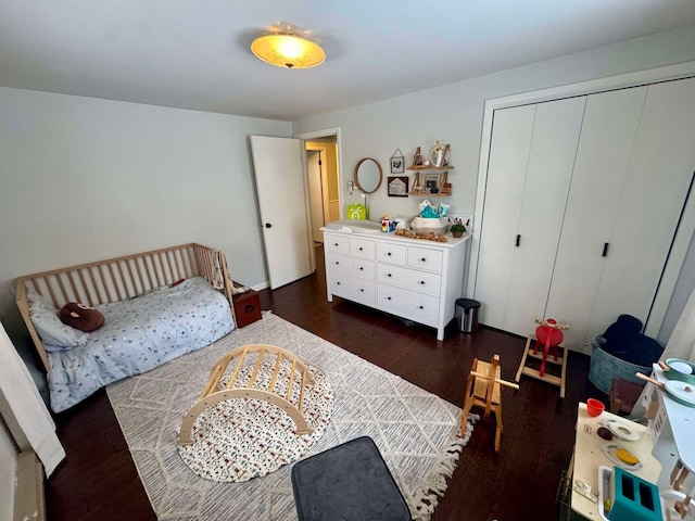 bedroom featuring dark wood-type flooring and a closet