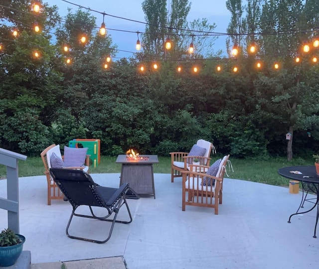 patio terrace at dusk featuring a fire pit