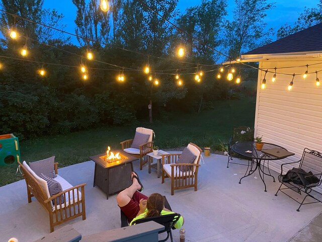 view of patio / terrace with an outdoor living space with a fire pit