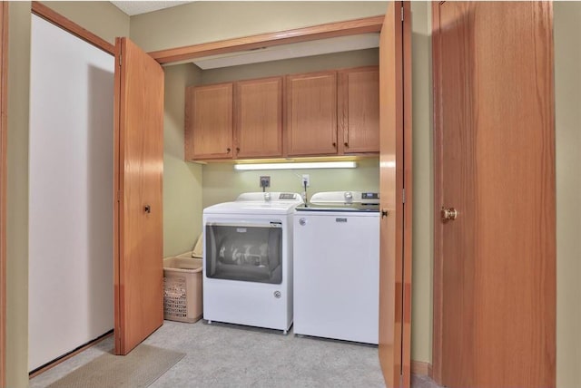 washroom with cabinets and washer and clothes dryer