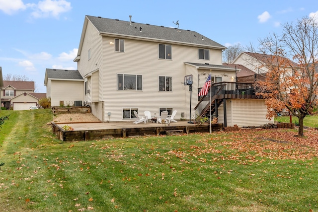 back of property with cooling unit, a yard, and a wooden deck