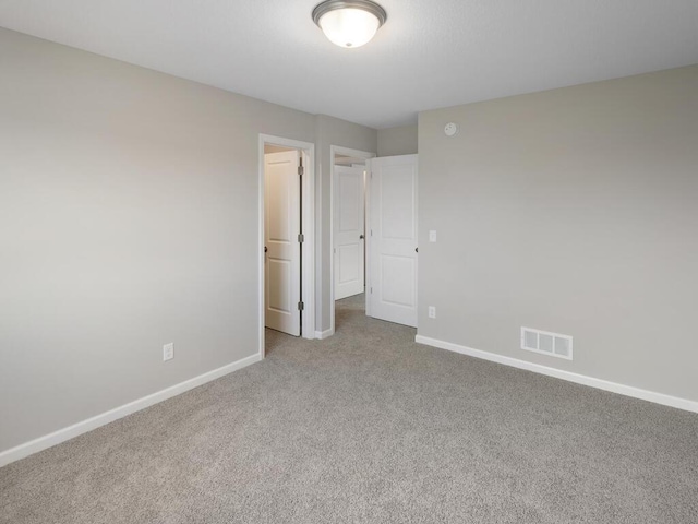 unfurnished bedroom featuring light carpet