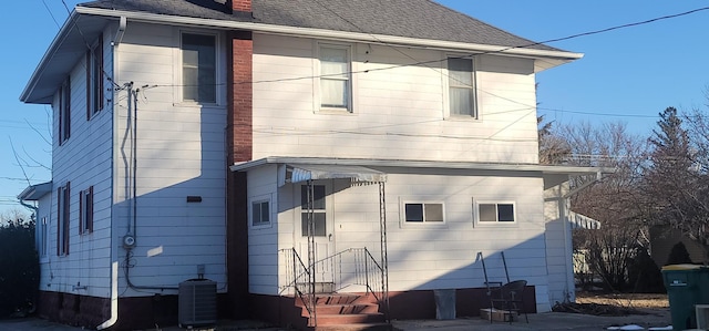 rear view of house featuring central AC unit