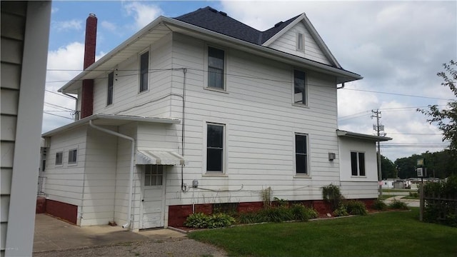 rear view of house with a lawn