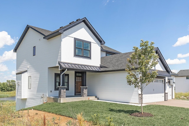 modern farmhouse style home featuring a front yard, a garage, and covered porch