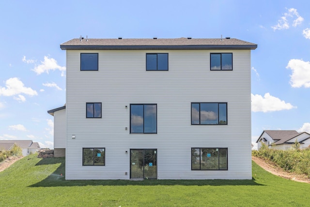 rear view of property with a lawn