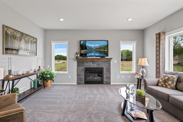 carpeted living room with a tiled fireplace