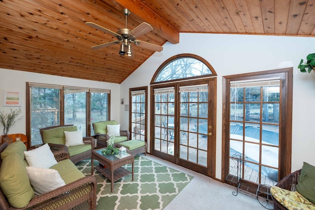 living room featuring wooden ceiling, carpet flooring, a wealth of natural light, and vaulted ceiling with beams