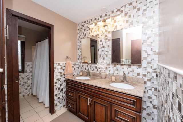 bathroom featuring tile walls, vanity, tile patterned floors, and a textured ceiling