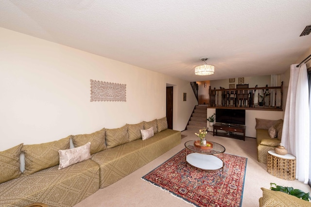 carpeted living room featuring a textured ceiling