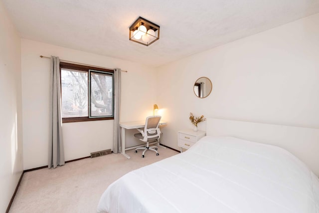 bedroom featuring light colored carpet