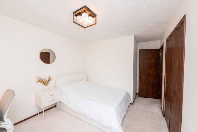 carpeted bedroom featuring a textured ceiling