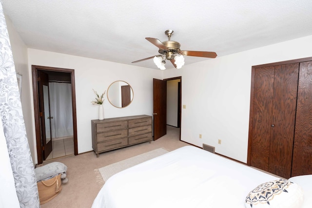 bedroom with light colored carpet, a closet, and ceiling fan