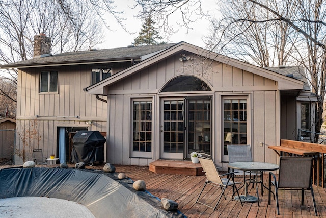 rear view of property featuring a deck