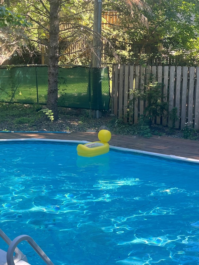 view of pool with a wooden deck