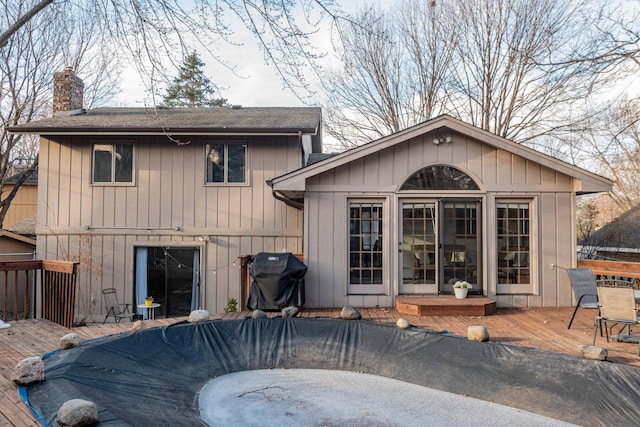 back of house featuring a wooden deck