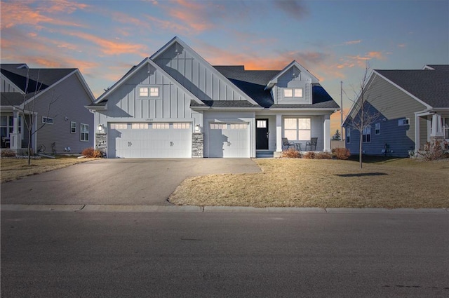 view of front facade with a yard and a garage